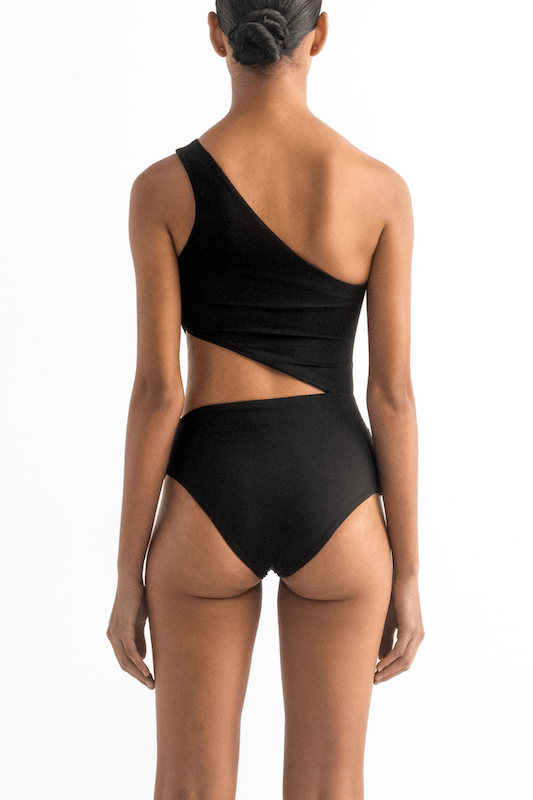 Picture of the back of a model wearing the Diana one piece by Encantadore Swimwear in black.