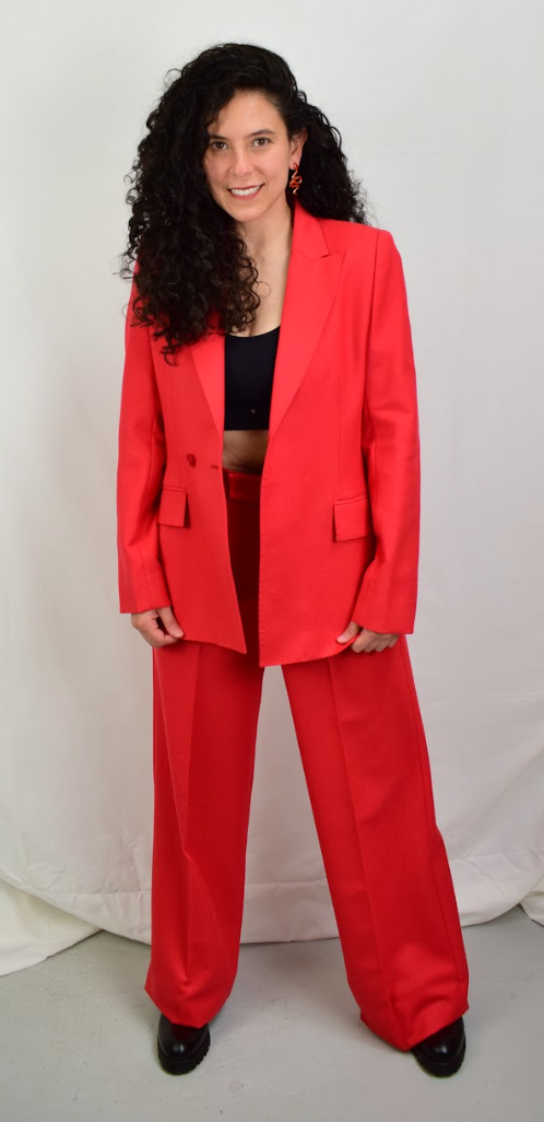 Model wearing a red blazer with red pants