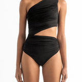 Front of model wearing the Diana One Piece swimsuit by Encantadore Swimwear. It has a cutout on the waist and one-shoulder look.