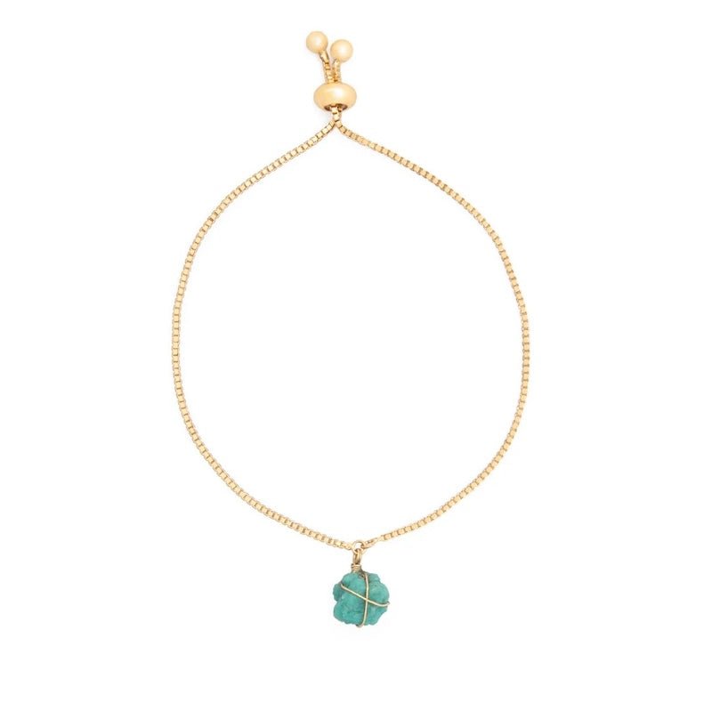 Image of a gold chain bracelet with a turquoise stone on it.The purpose of the image is to highlight the bracelet because it is on sale at EVAMAIA boutique in Studio City, CA.