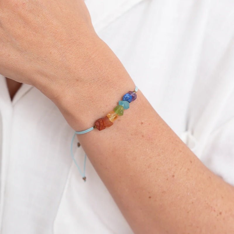 Close up image of a woman wearing a bracelet with 7 colorful stones. The purpose of the image is to highlight the bracelet because it is for sale at EVAMAIA boutique in Studio City, CA and online.