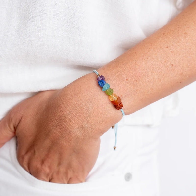 Close up image of a woman wearing a bracelet with 7 colorful stones. The purpose of the image is to highlight the bracelet because it is for sale at EVAMAIA boutique in Studio City, CA and online.