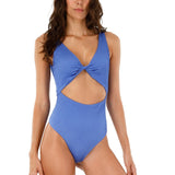 Image of a woman standing against a white background. She's wearing a blue one piece swimsuit. The purpose of this image is to highlight the swimsuit.