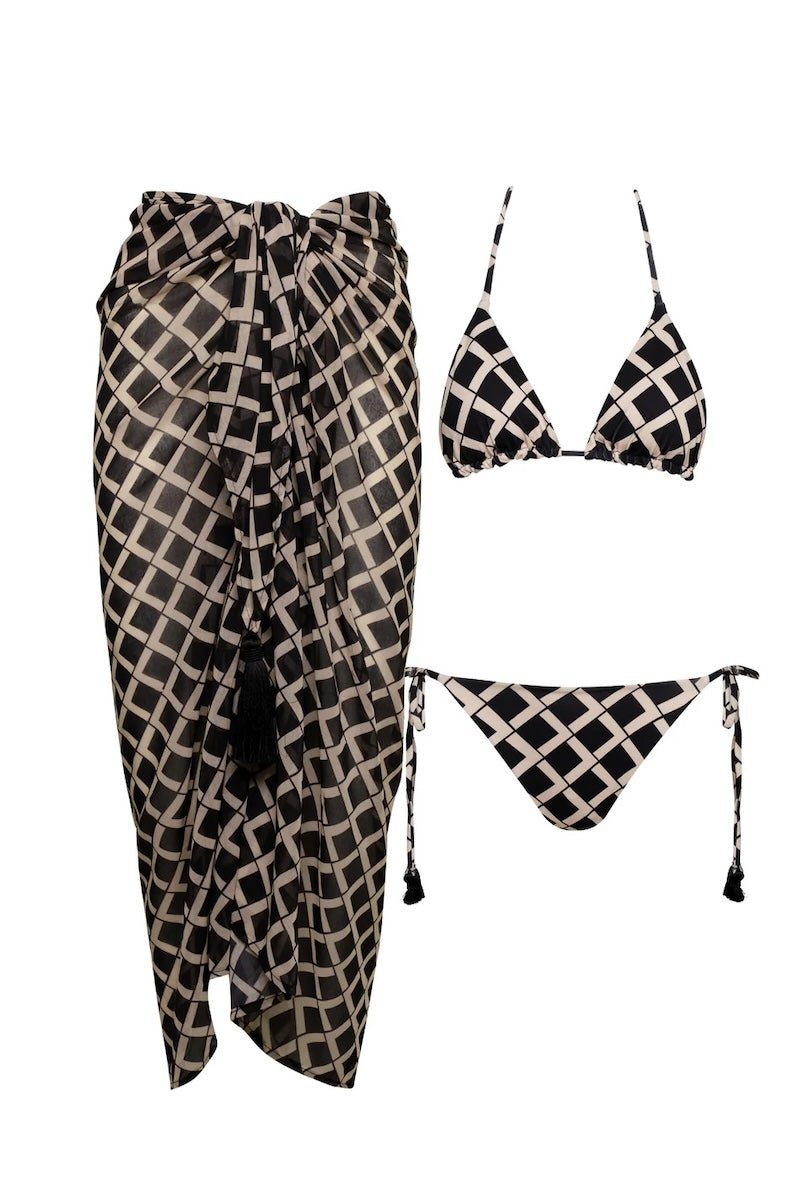 Image of a black and white bikini set and matching sarong. They are set on a white background. The purpose of this image is to highlight the clothing because it is for sale at EVAMAIA boutique in Studio City, CA.