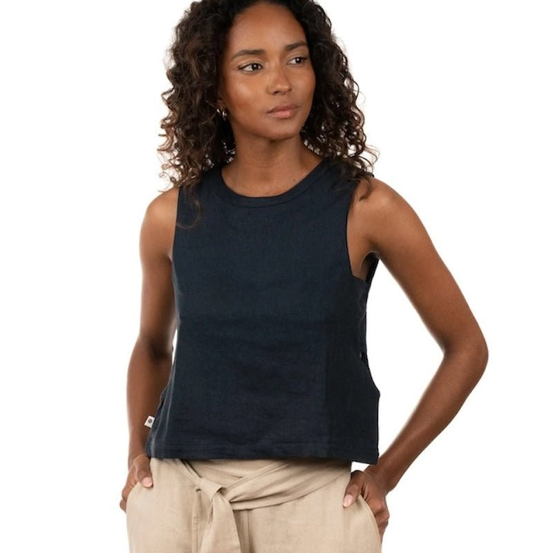 Woman wearing a linen top and pants. She's standing behind a white background. The purpose of this image is to highlight the clothing, which is made in Colombia and sold at EVAMAIA Boutique in Studio City, CA.