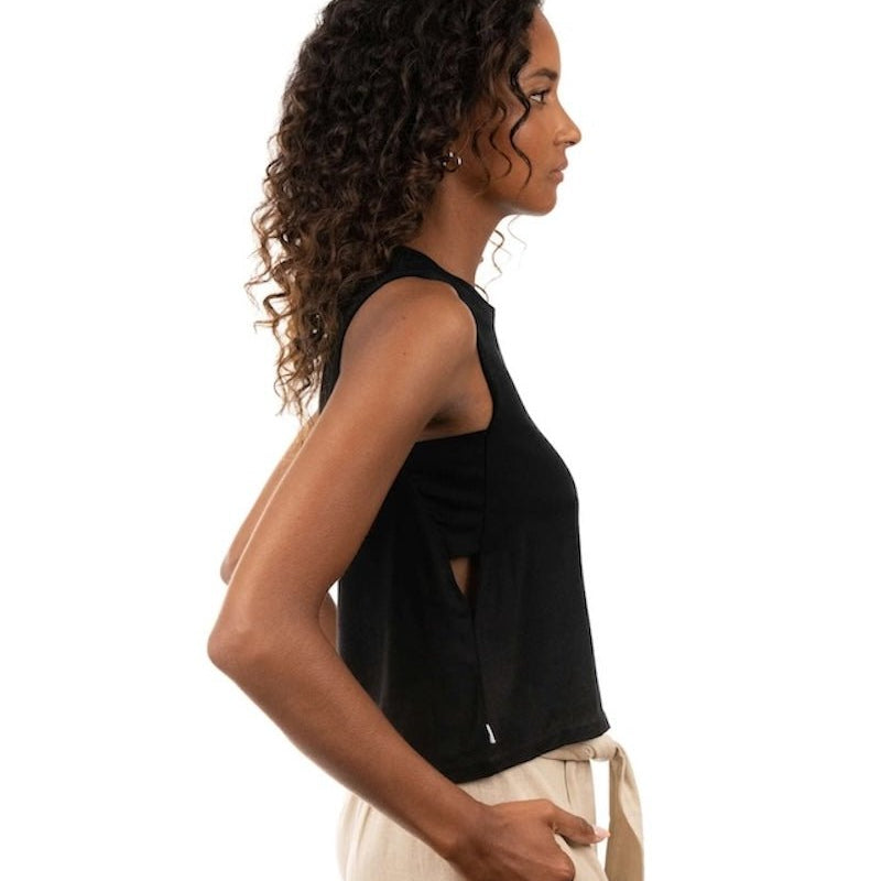 Woman wearing a linen top and pants. She's standing behind a white background. The purpose of this image is to highlight the clothing, which is made in Colombia and sold at EVAMAIA Boutique in Studio City, CA.